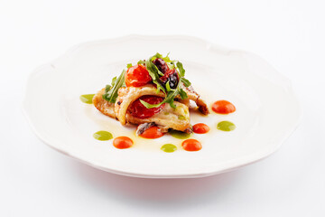 Fried white fish fillet with tomatoes and arugula
