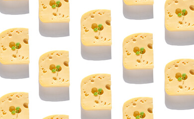Creative cheese pattern with harsh shadow. Maasdam with holes white background sunlight flat lay. Healthy breakfast sandwich, calcium rich dairy food concept top view. Delicious snack with green leaf.