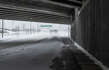 Bike path under the snow. Close-up of snow on the road. Impossible to take a bike. Snow storm. Road covered with snow in the middle of a storm, blizzard, winter. cycle route. Climate change