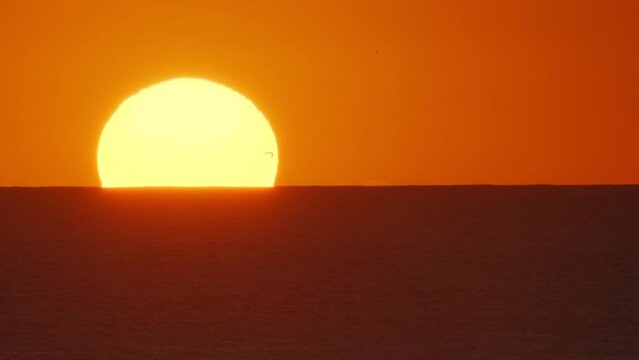 Beautiful evening sunset with big Sun on Atlantic ocean. Beautiful screensaver for any of your projects.