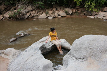 woman enjoyed hiking by the river in the mountains.