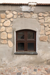 Texture background, window on the wall of a wooden and stone house