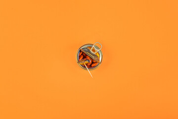 Pickled mussels taken out of the can with a toothpick. Orange sauce.