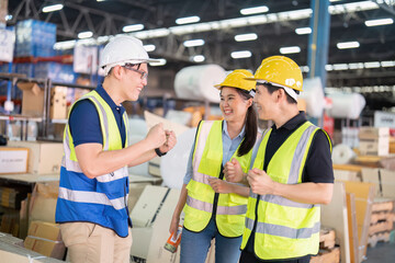 Staff in large storage warehouse together cheerful after work completed hand touching congrats