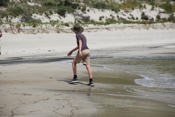 Boy walking on the beach