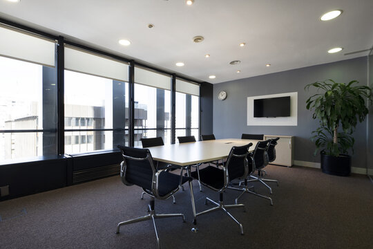 Modern Boardroom Of A Modern Office With Long Wooden Table With Swivel Chairs And Newly Carpeted Floors