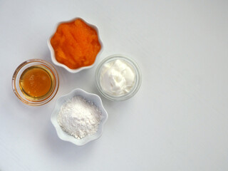 Fototapeta na wymiar Natural face mask from persimmon, yogurt, honey and rice flour.
