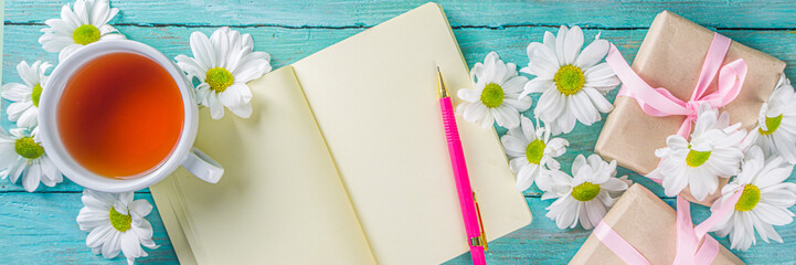 Cozy summer background with tea and daisies