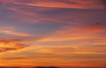 Fototapeta na wymiar sky with gentle colorful clouds. Panoramic view of real sunset orange sunset