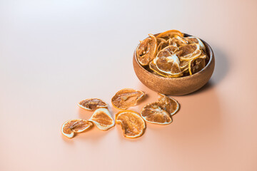 Dried lemon slices in wooden plate. Healthy nutrition and diet for weight loss. Tea ceremonies.