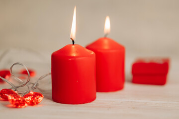 Beautiful composition with red candles on the white wooden table. Romantic love image