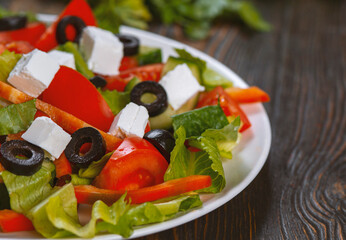 Traditional greek salad with fresh vegetables, feta cheese, black olives, ingredients for cooking Greek salad oil, thyme, cherry tomatoes, cucumbers, salt