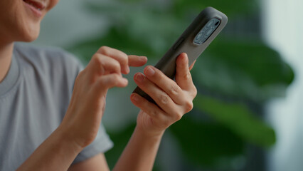 Asian woman happy smiling using smart phone at home office.