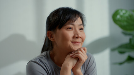 Fototapeta na wymiar Asian woman happy smiling sitting at home office having think positive.