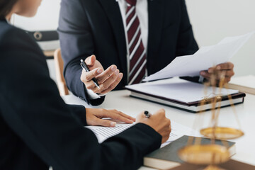 Lawyer with lawsuit meeting with client discussing with contract agreement at courtroom