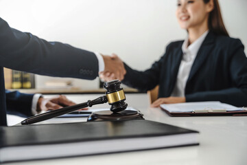 Lawyer consultant shaking hand with client sign contract agreement document. in law firm. Business meeting Handshake.  