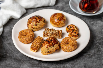 Salty cookies on a dark background. Types of cookies with sesame seeds and seeds in a plate. close up
