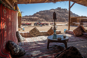A hookah stands on a table in a Bedouin town. Sunny summer day. Bedouin city in the desert.