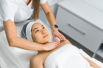 High-angle shot of a woman laying down with her eyes open and receiving a massage. Beauty concept. High quality photo