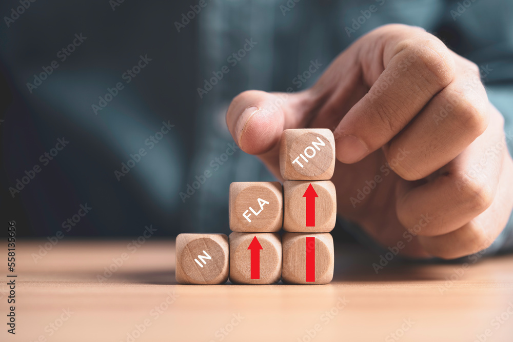 Poster inflation wording print screen on wooden cube block with red up arrow on coins stacking for increasi