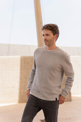 Obraz premium Caucasian male model posing outdoors in a sunny day in casual clothes.