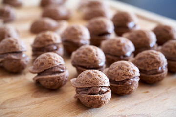 Preparation of Christmas cookies in the form of nuts filled with cream