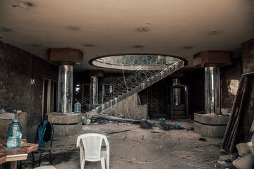 Interior of an old abandoned building. Shabby walls. Benton stairs. Empty abandoned building.