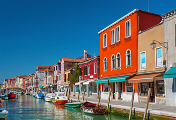 Fototapeta na wymiar Murano island canal, colorful houses and boats, Venice, Italy.