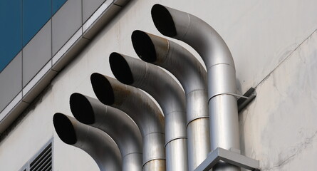 Industrial vent pipes on building facade