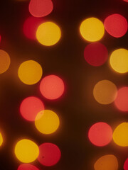Abstract festive blurry bokeh image of street lights in the evening for use as a background.