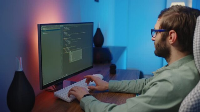 The view from the back of the programmer at work can be seen as the fingers type the code on the keyboard. Develop applications and work with data.