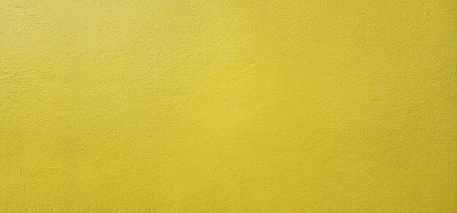 The surface of a blank cement wall painted bright yellow. Suitable for wall decoration, background image or put text. The walls are smooth plaster painted yellow. 
