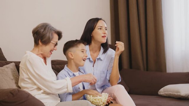 Multigenerational Family Watching Their Favorite Comedy Movie With Popcorn