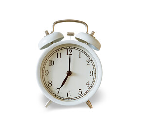 White vintage alarm clock showing 7.00 o'clock isolated on white background.