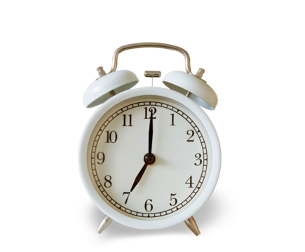 White vintage alarm clock showing 7.00 o'clock isolated on white background.