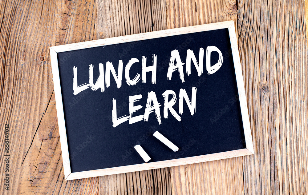 Poster lunch and learn text on a chalkboard on the wooden background