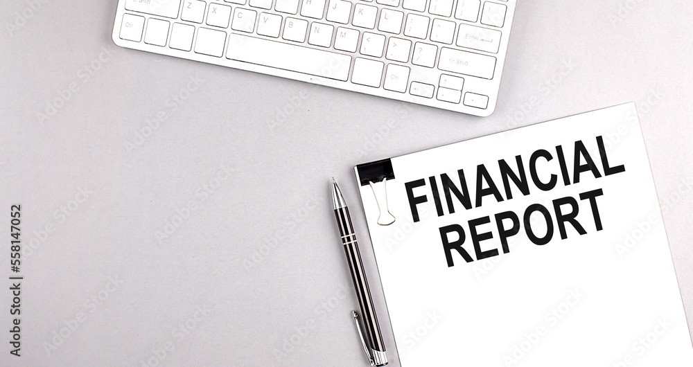 Poster financial report text on paper with keyboard on grey background