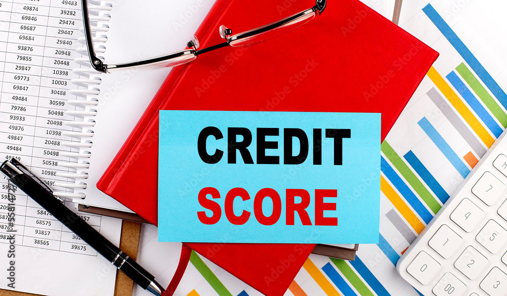 Poster credit score text on sticky on red notebook on chart background