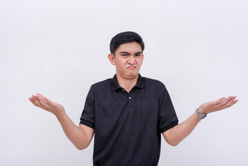 A clueless young man shrugs, claiming to have no knowledge. Isolated on a white background.