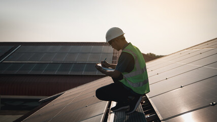 Service engineer checking solar cell on the roof  for maintenance if there is a damaged part., Clean energy concept.