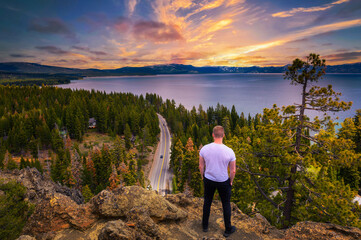 Fototapeta premium Hiker enjoying sunset over Lake Tahoe from the Eagle Rock in California