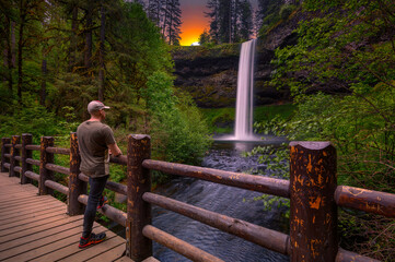Tourist looking at the South Falls in Silver Falls State Park, Oregon