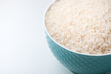 Bowl full of rice on white background.  Close-up. Copy-space. Ingredient for a healthy diet.