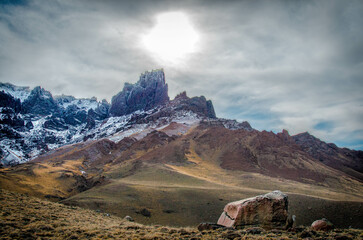 Mountaineous mountain range shaped like a man sleeping in winter of Patagonia with many colors.