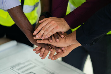 Workers and engineers work together to build a successful project. teamwork concept Collaboration with partners and engineering tools in the workplace or construction site