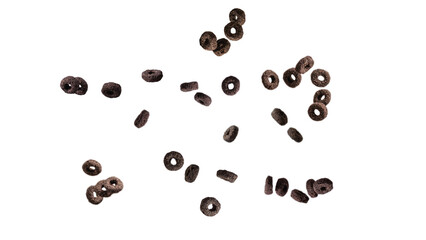 Chocolate rings cereal spill out into a bowl. Breakfast.