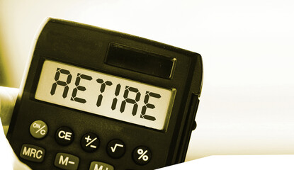 Retire word on calculator display. Retirement career business concept