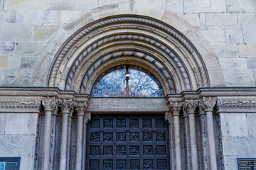 Main entrance of famous protestant church Great Minster at the old town of Zürich on a cloudy autumn day. Photo taken November 4th, 2022, Zurich, Switzerland.