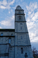 Tower of famous protestant church Great Minster at the old town of Zürich on a cloudy autumn day. Photo taken November 4th, 2022, Zurich, Switzerland.