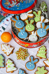 Ginger cookies in shape of rabbits,Christmas trees and snowflakes  with sugar icing - light blue, green, white.